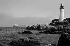 Ship Leaving Harbor in Fog  by Portland Head Lighthouse - BW